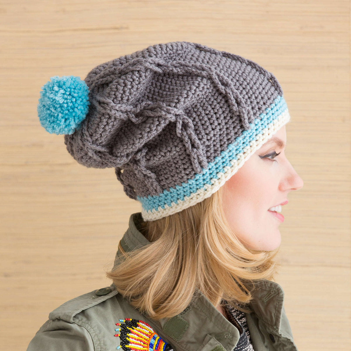Red Heart Cabled Hat with Pompom Pattern | cables, Hats, Women